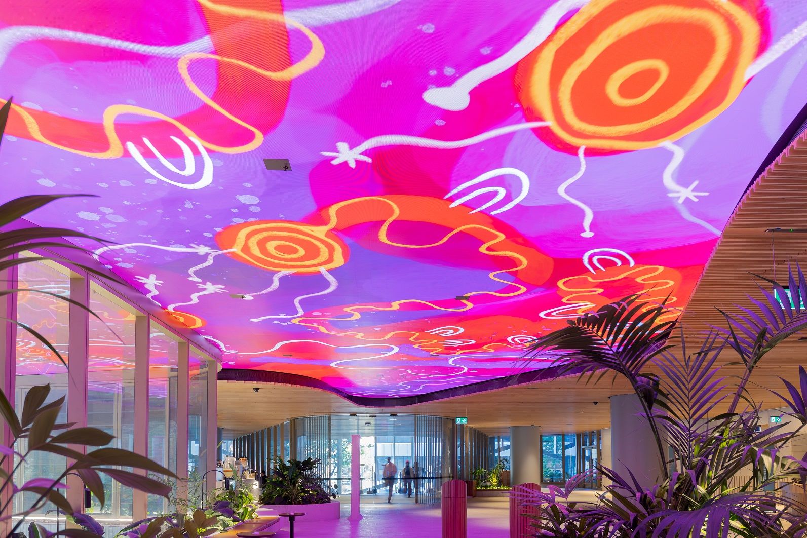 Photo of Mirvac Heritage Lanes commercial lobby foyer in Brisbane Australia showing digital placemaking art screen with vibrant blue indigenous Australian aboriginal artwork created by artist Rachael Sarra in partnership with VANDAL.