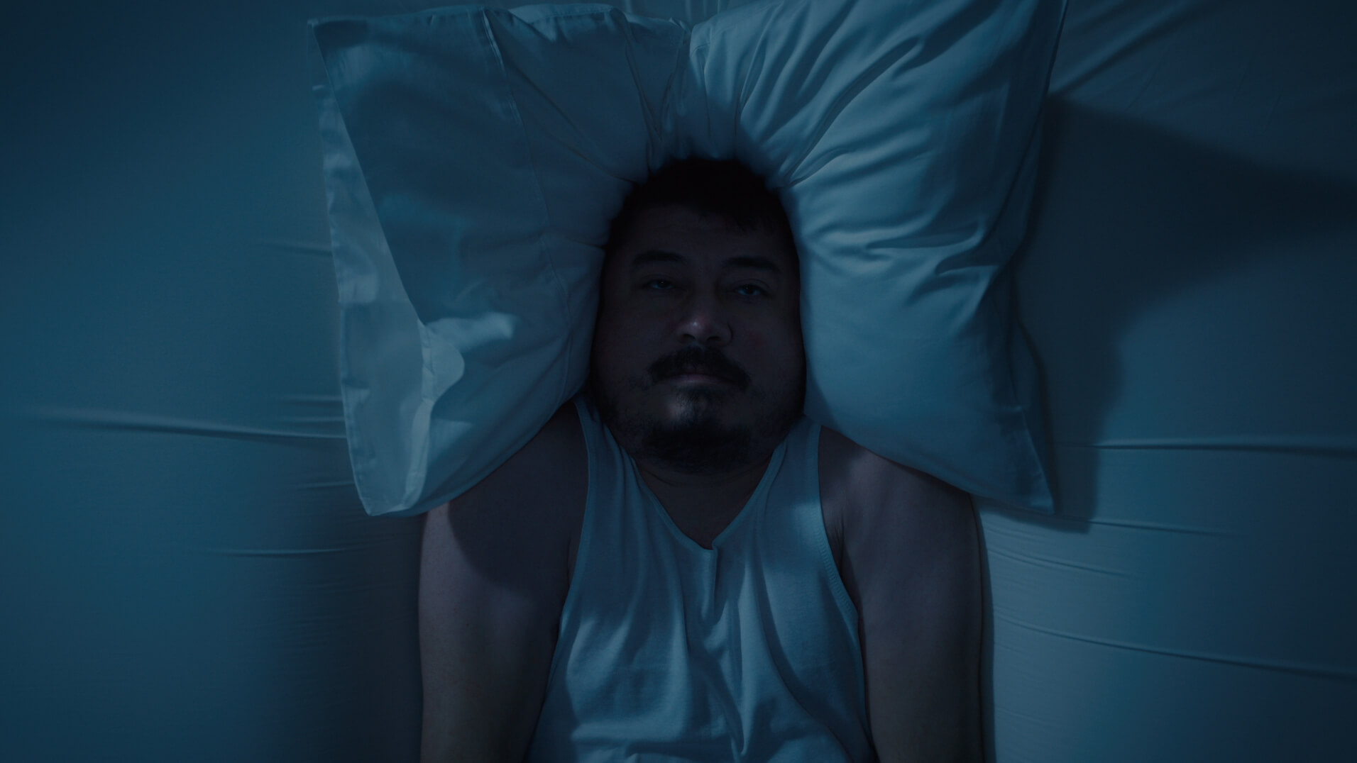 Koala Kloudcell television campaign commercial showing man sinking into his bed.