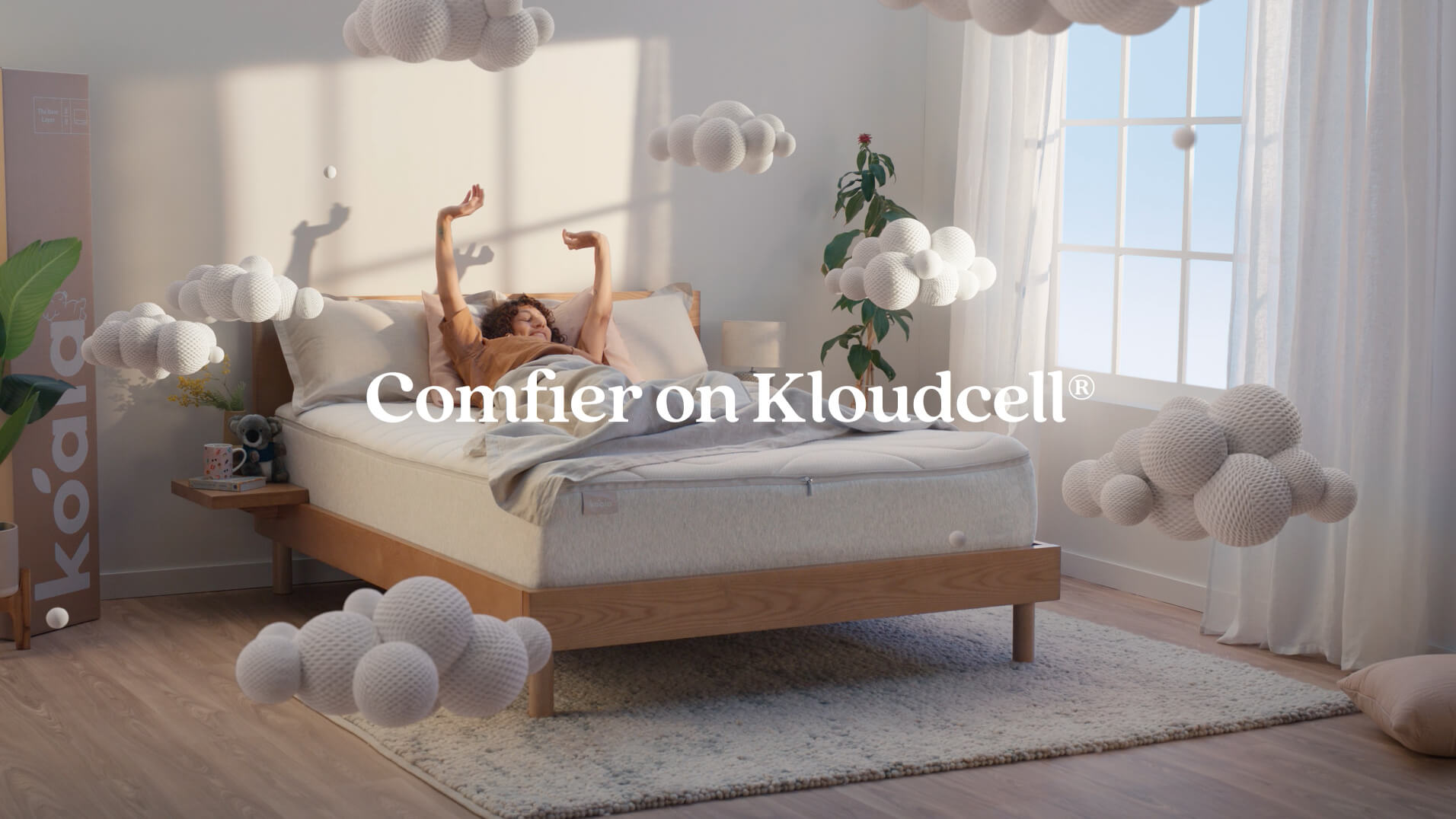 Koala Kloudcel television campaign commercial showing woman laying on bed sleeping peacefully as VFX foam clouds surround her with text saying comfier on Kloudcell