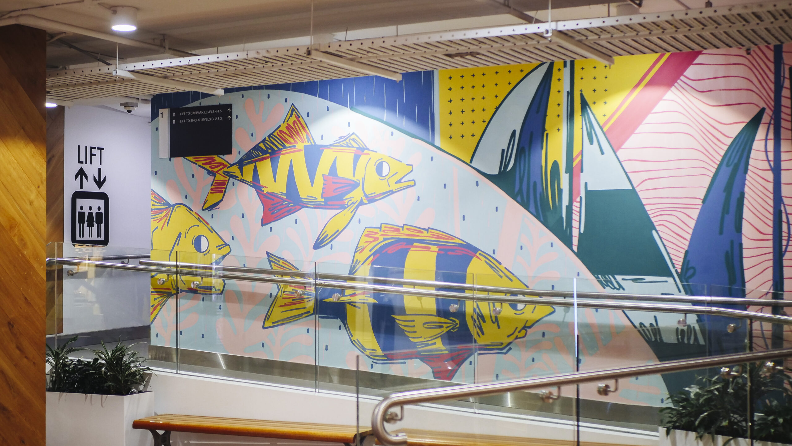 geometric multicoloured wall mural featuring fish inside a shopping centre produced by VANDAL for Mirvac