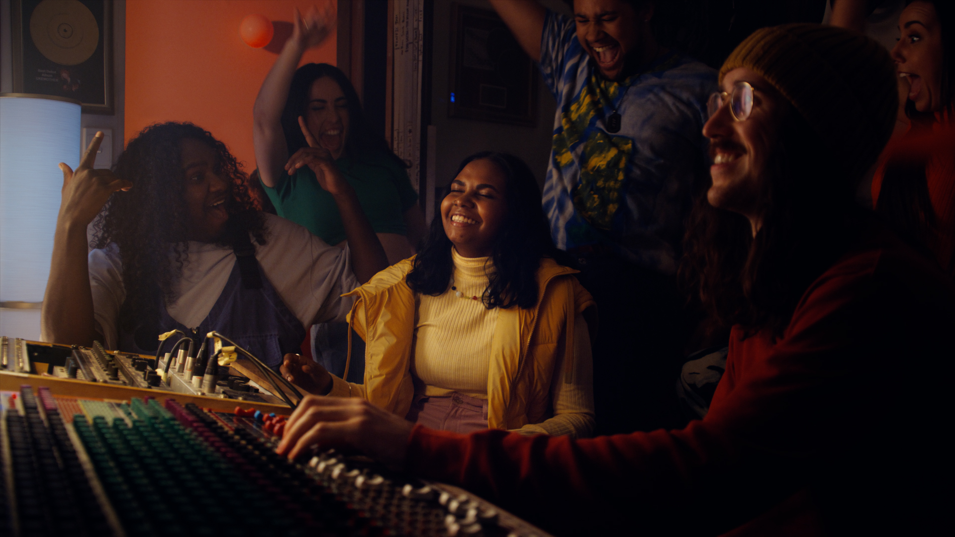Still from google Helpfulness campaign TVC featuring Baker Boy and a young woman accompanied by happy people in a recording studio