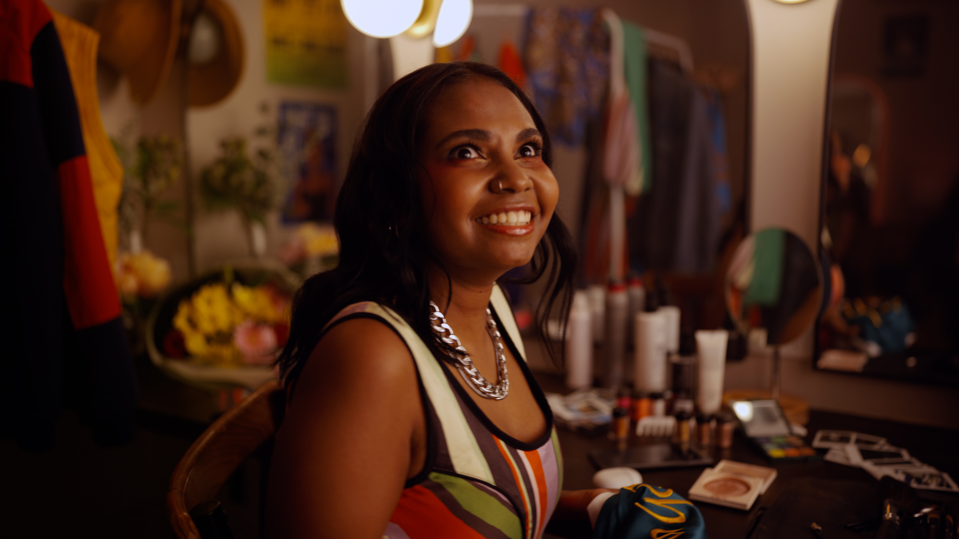 Still from google Helpfulness campaign TVC featuring a young woman smiling in a dressing room