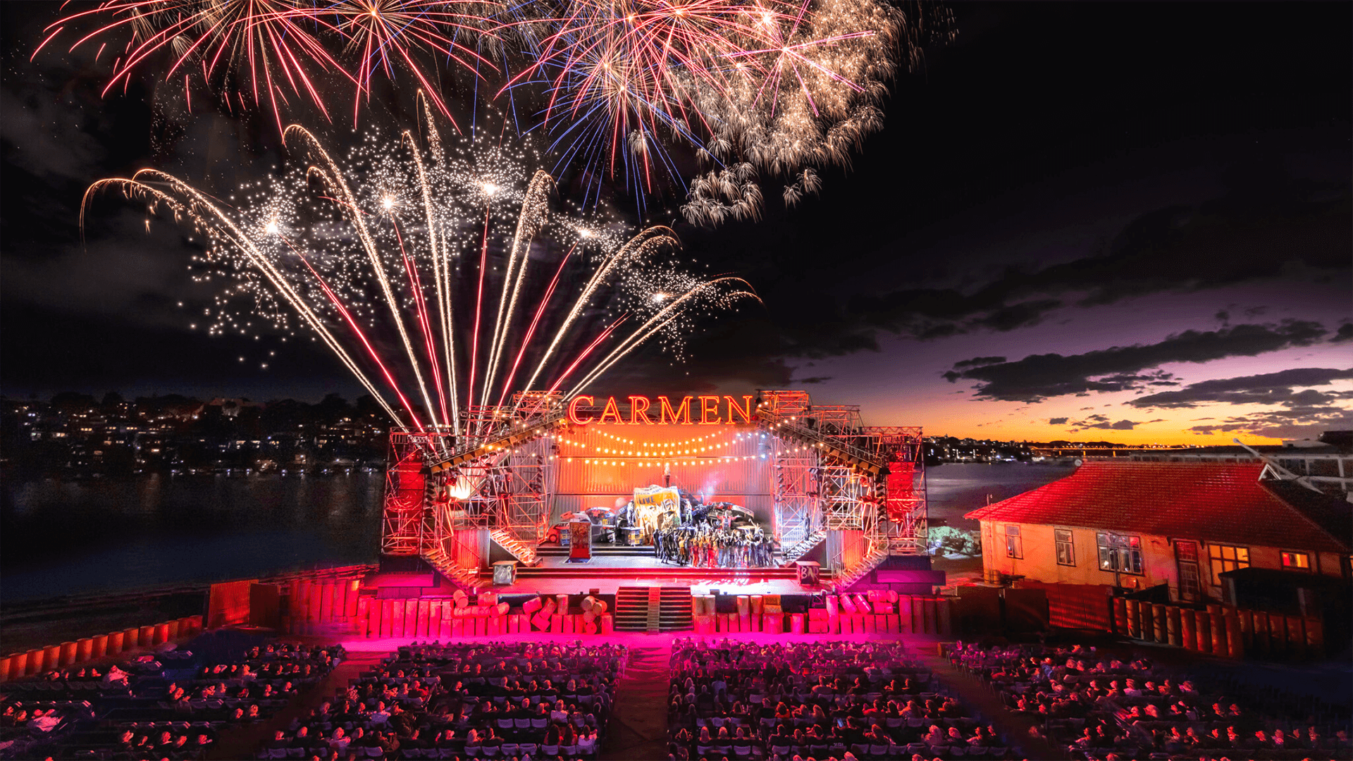 The stage of Carmen on Cockatoo Island flanked by fireworks and graphics by VANDAL