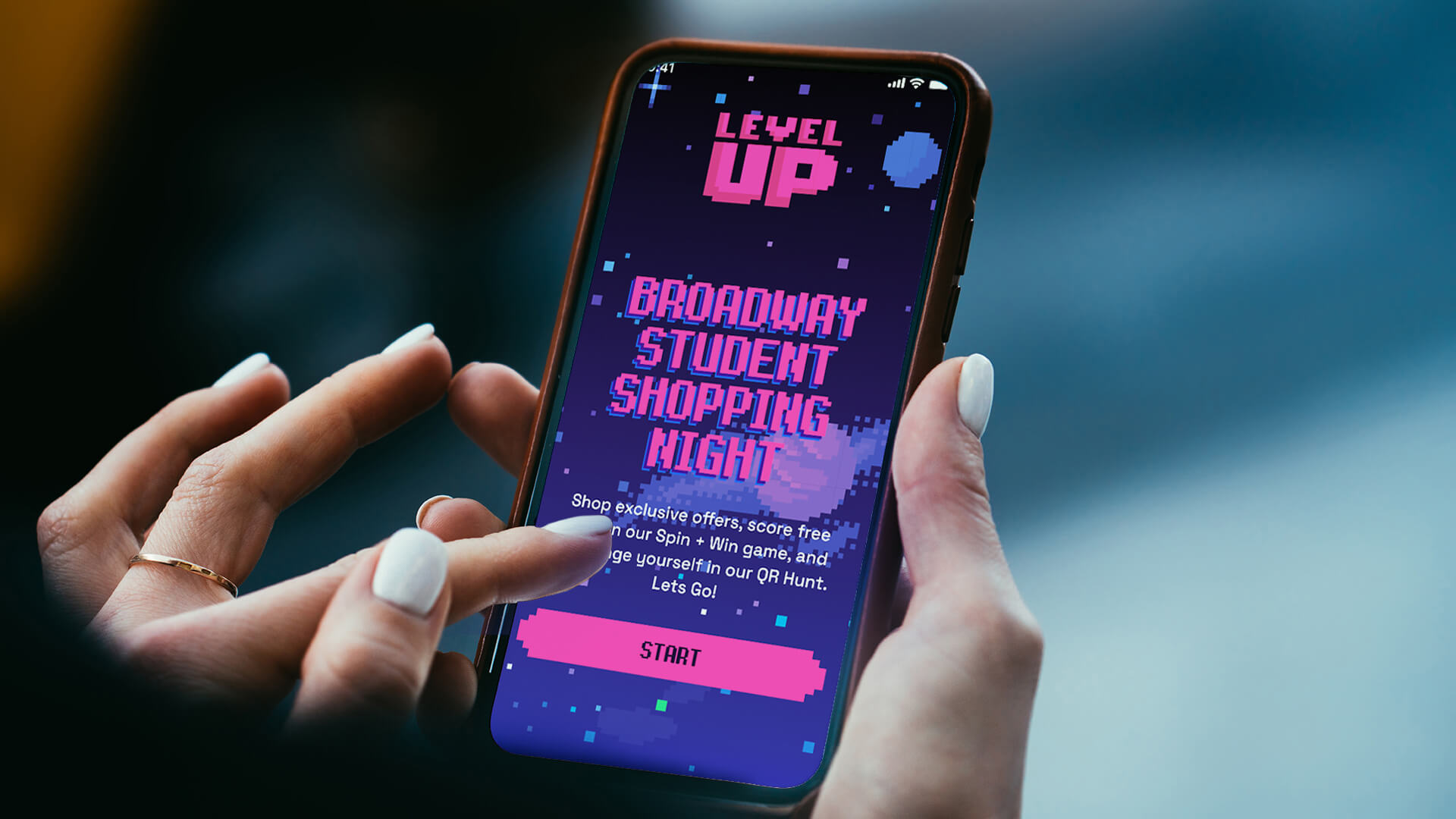 consumer holding a phone displaying branded design content for Broadway Student Shopping Night - Level Up experiential brand activation